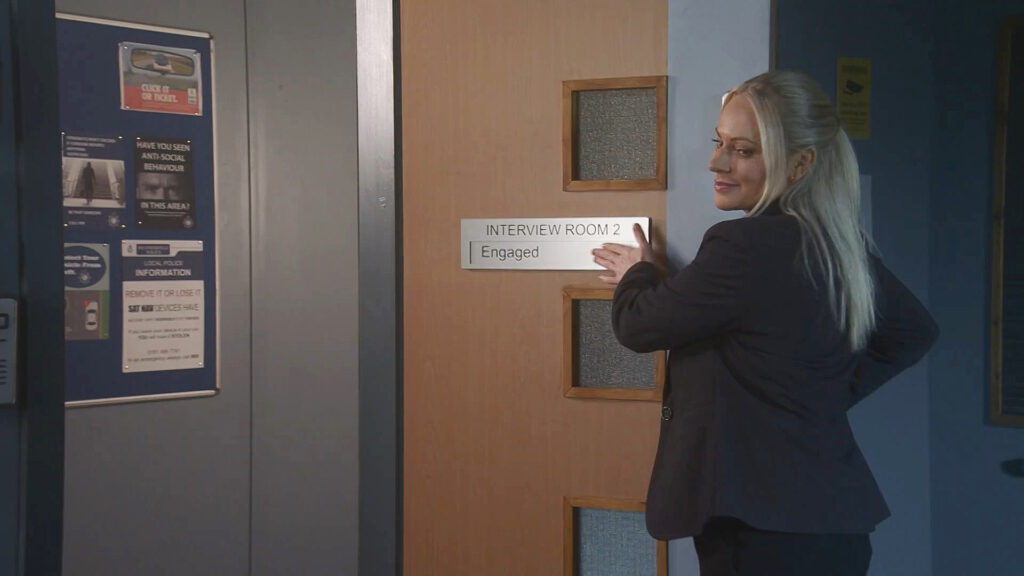 Lisa changes the sign on the door to 'engaged'